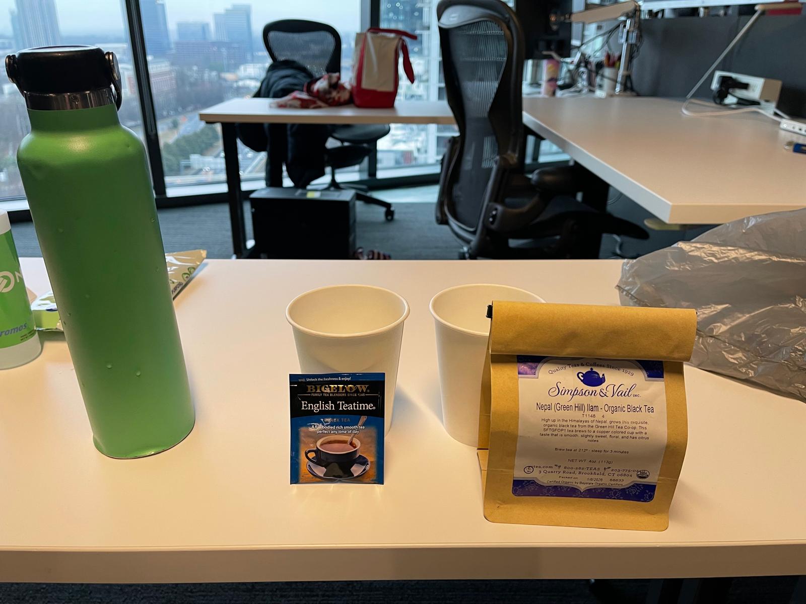 The contenders - a Bigelow tea bag and a bag of loose leaf tea. Also pictured is my green water bottle, containing soon-to-be-poured boiling water, and 2 paper cups that shall endure the wrath thereof.